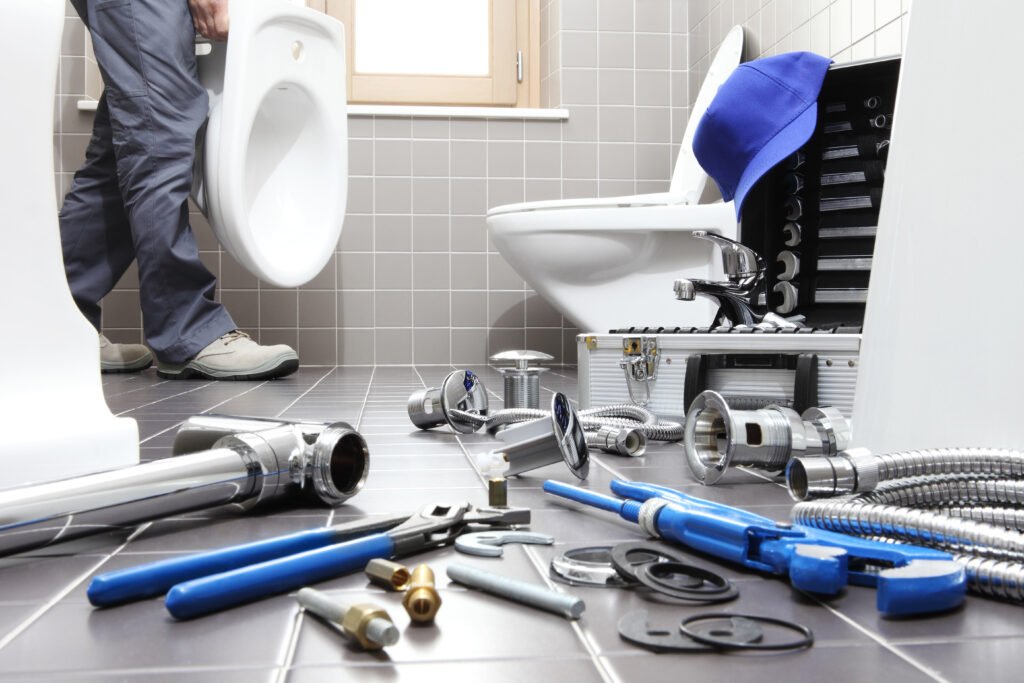 plumber at work in a bathroom, plumbing repair service, assemble and install concept