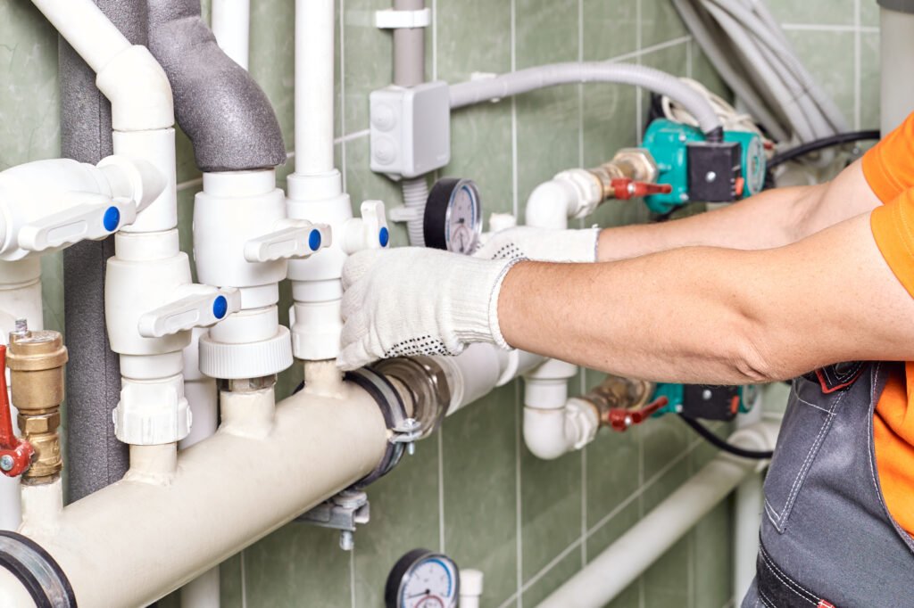 engineer controlling the heating pipes at the boiler room.